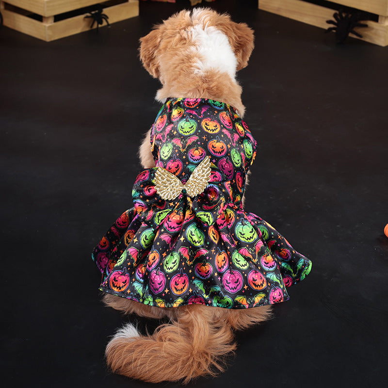 Dog wearing a Halloween-themed dress with pumpkins and a bow on a dark background