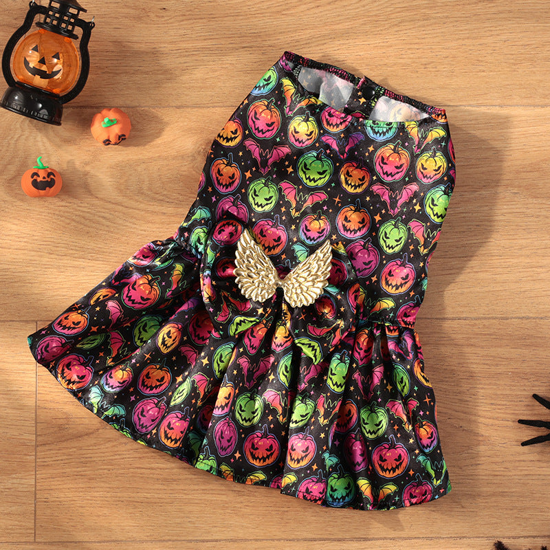 Colorful Halloween-themed dress with pumpkins and ghosts on a wooden surface.