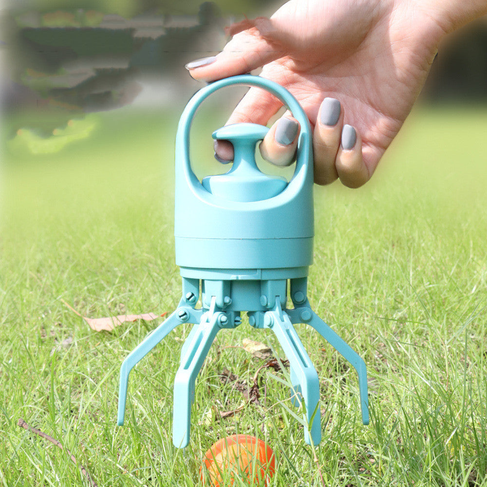 Turquoise dog toy with a handle held by a hand on grass