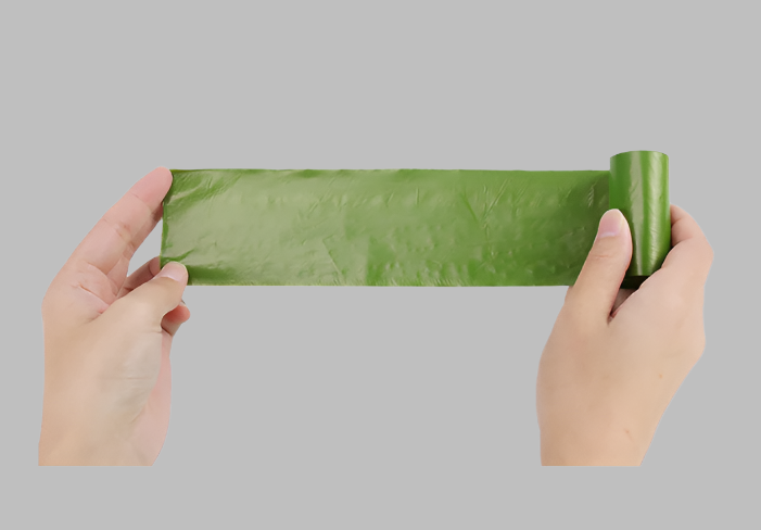 A person holding a stretched Biodegradable Pet Waste Bags roll, showcasing its length and durability for convenient use