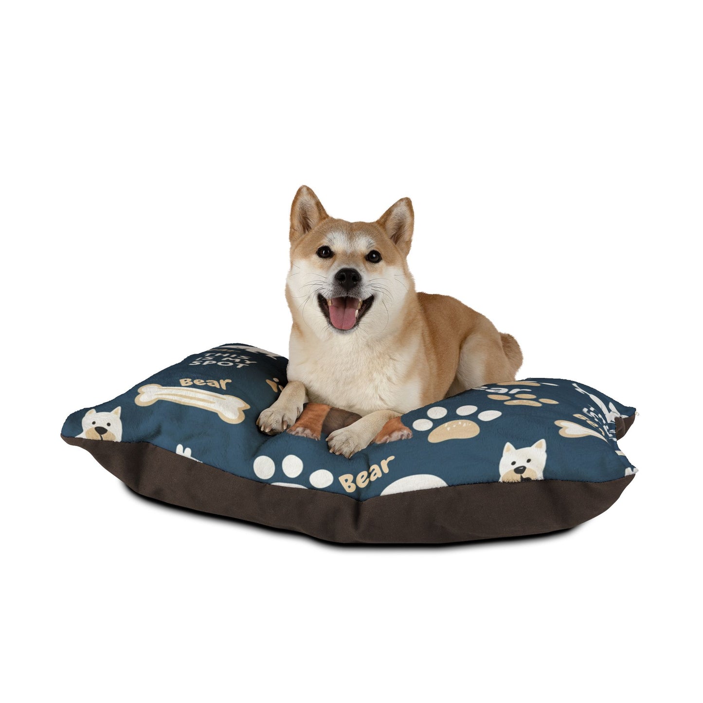Dog sitting on a blue pet bed with paw prints and dog illustrations on a white background