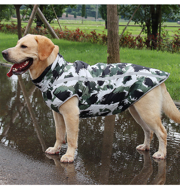 Dog wearing camouflage waterproof vest on wet ground with reflective strip.