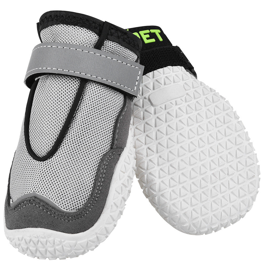 breathable dog boots and wear-resistant grey dog shoes protecting paws in outdoor conditions close up