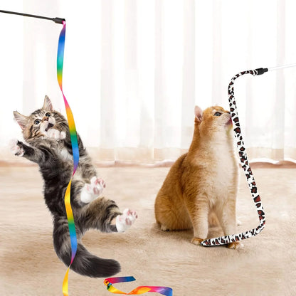 Two cats playing with colorful cat toys on a light wooden floor.