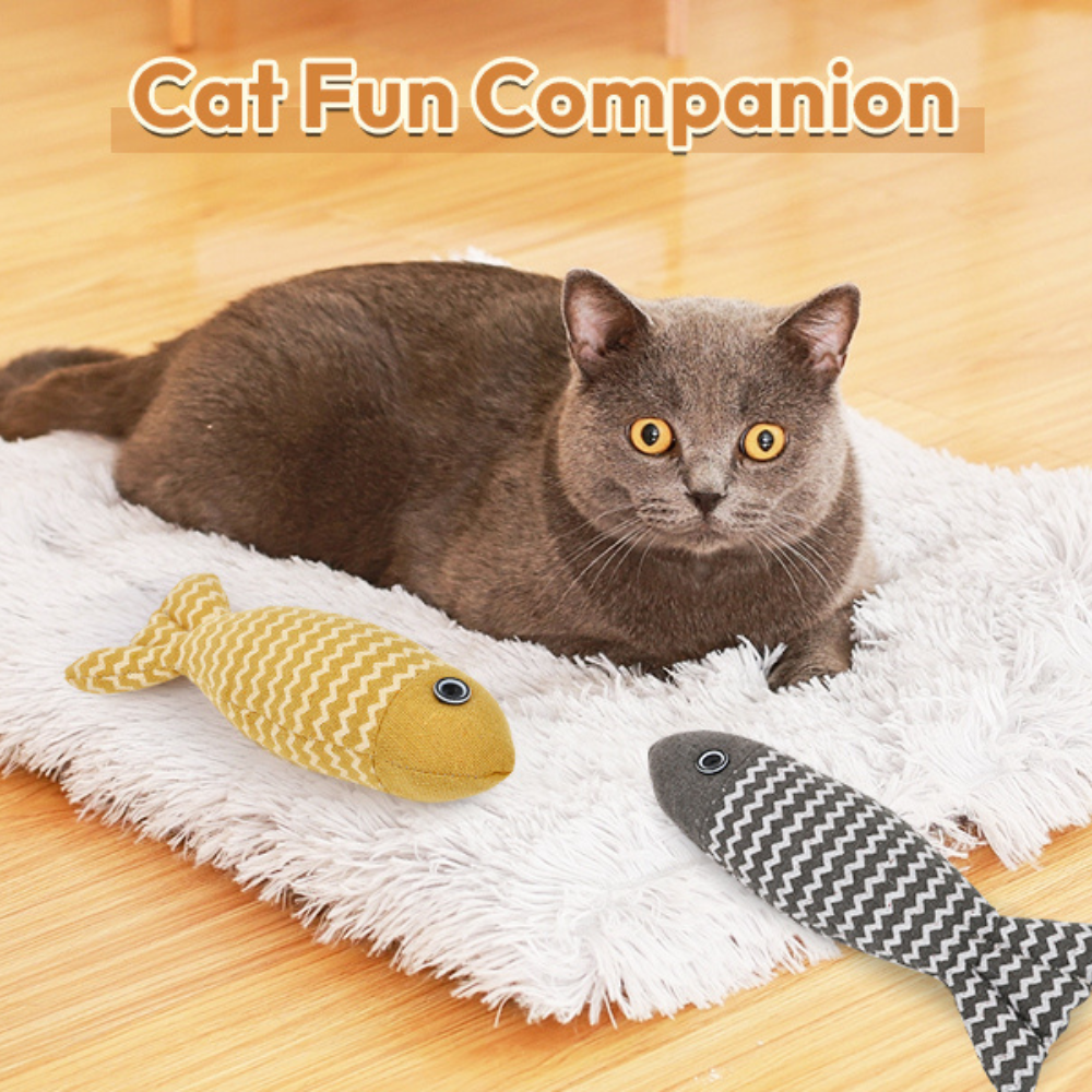 Cat lying on a white rug with two fish-shaped cat toys, labeled 'Cat Fun Companion'.