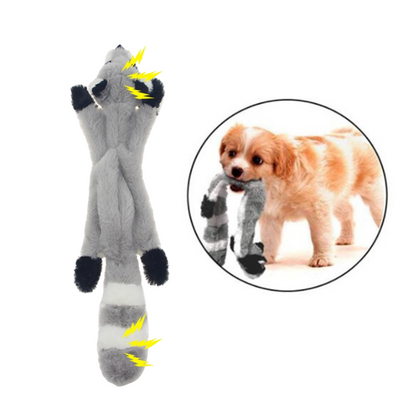 Dog toy resembling a gray fox with black paws and yellow highlights, next to a dog holding the toy.