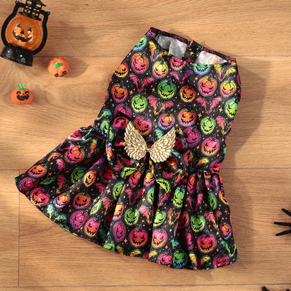 Colorful Halloween-themed dress with pumpkins and ghosts on a wooden surface.