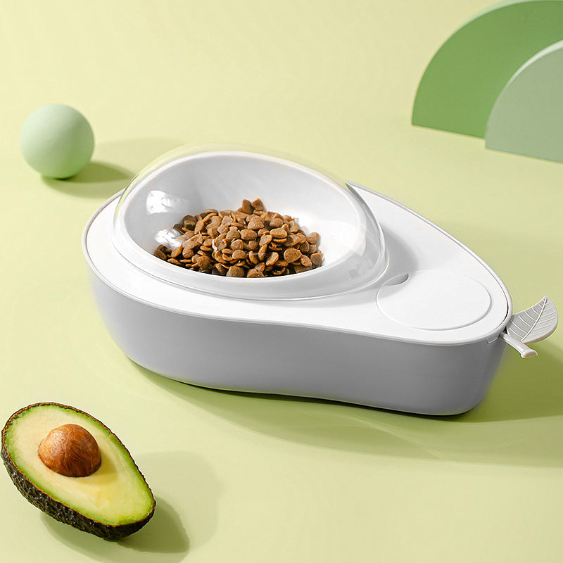 White Cat Feeder Bowl with pet food on a light green background with an avocado half.