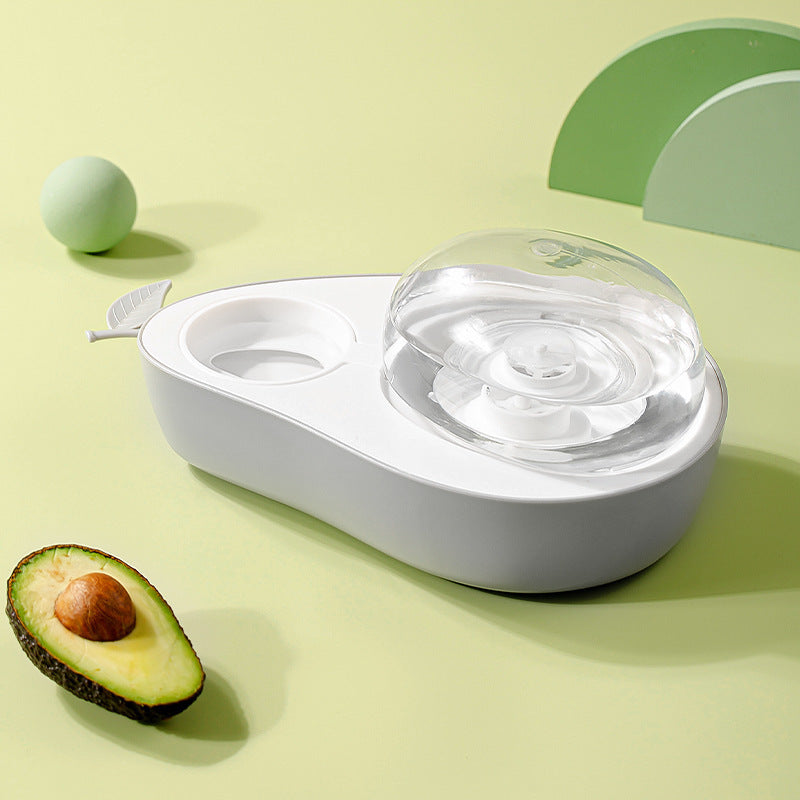 White Cat Feeder Bowl pet water fountain with clear water bowl on a light green background, accompanied by an avocado and a green ball.