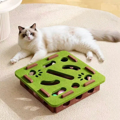 Cat lying on a green and brown cat toy on a carpeted floor.