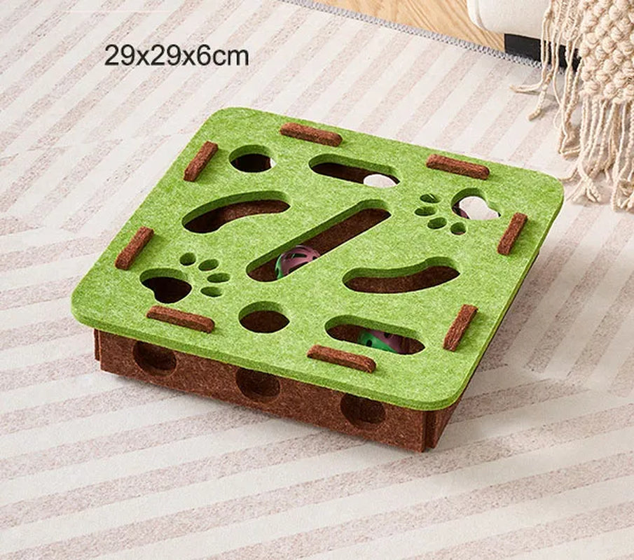 Green and brown puzzle toy for small animals on a striped surface