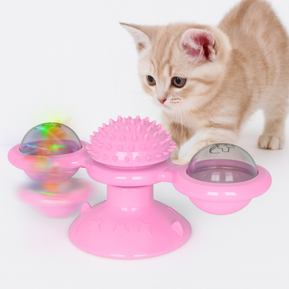 Cat playing with a pink Cat Rotating Windmill Toy with colorful ball inside