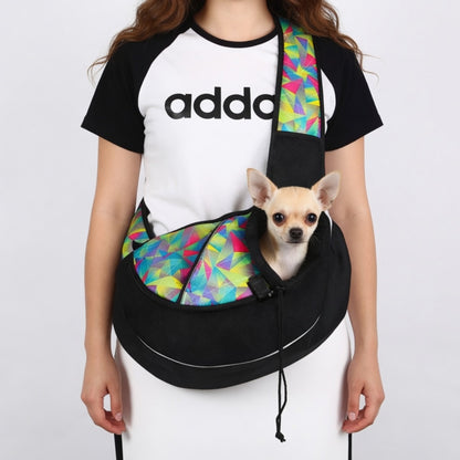 Person wearing a colorful Dog Sling Carrier Bag with a small dog inside, on a plain background