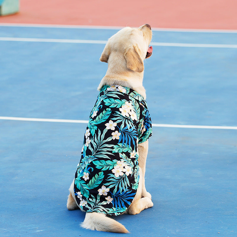 Hawaiian pet shirt for dogs and cats with a floral leaves print, perfect for summer. A stylish and comfortable option for your pet's warm weather wardrobe dog posing with it