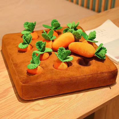 Plush carrot toys on a brown cushion on a wooden surface
