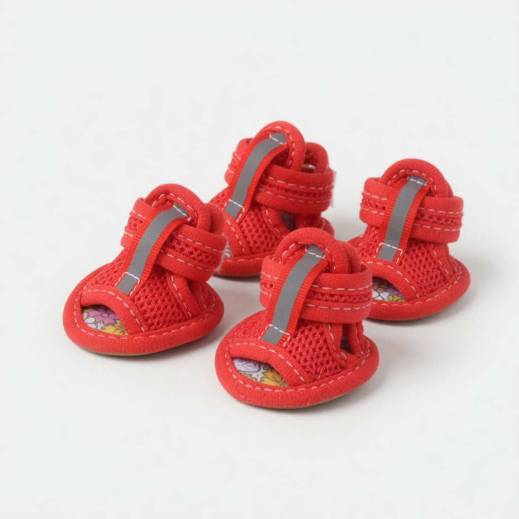 Four red dog sandals in a white background