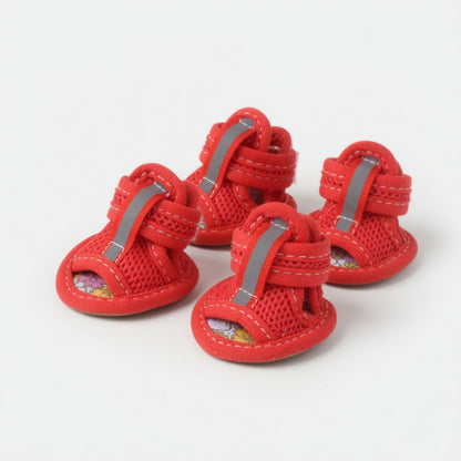 Four red dog sandals in a white background