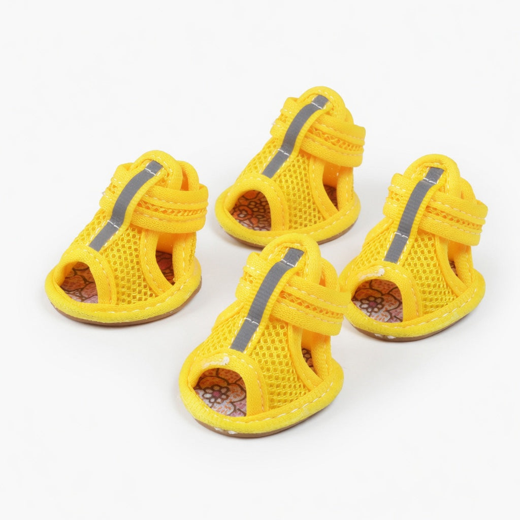 Four yellow dog sandals in a white background