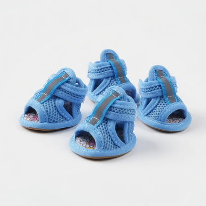 Four blue dog sandals in a white background