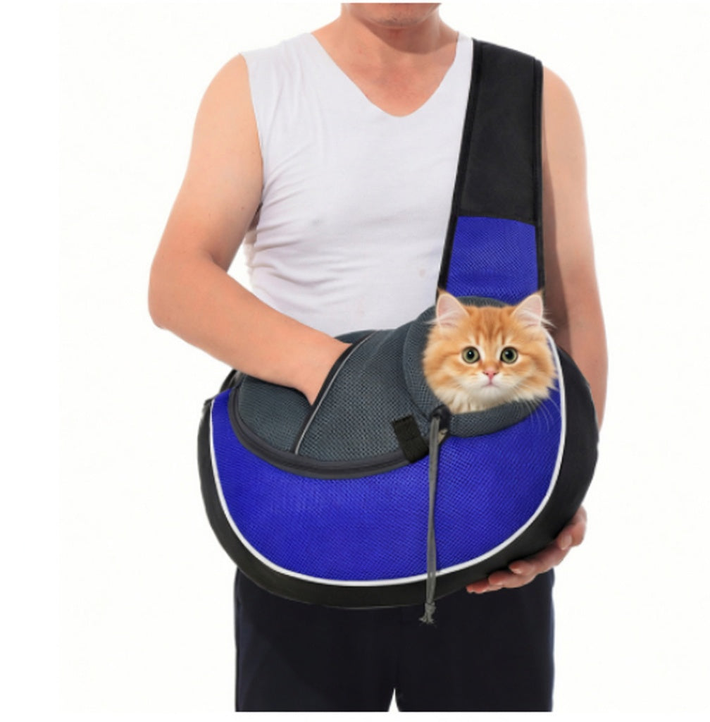 Man holding a blue Dog Sling Carrier Bag with his cat inside Happy Pets. 