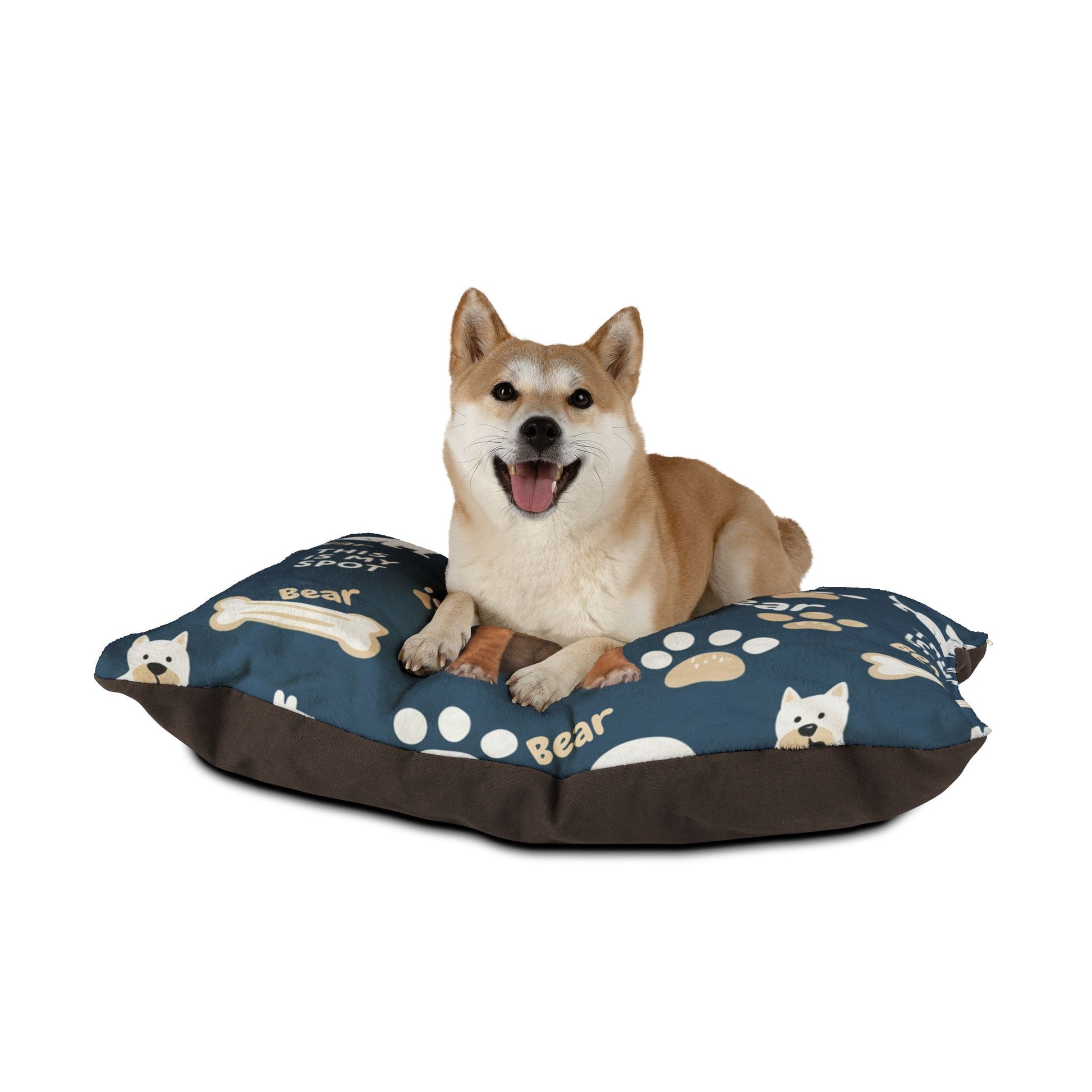 Dog sitting on a blue pet bed with paw prints and dog illustrations on a white background