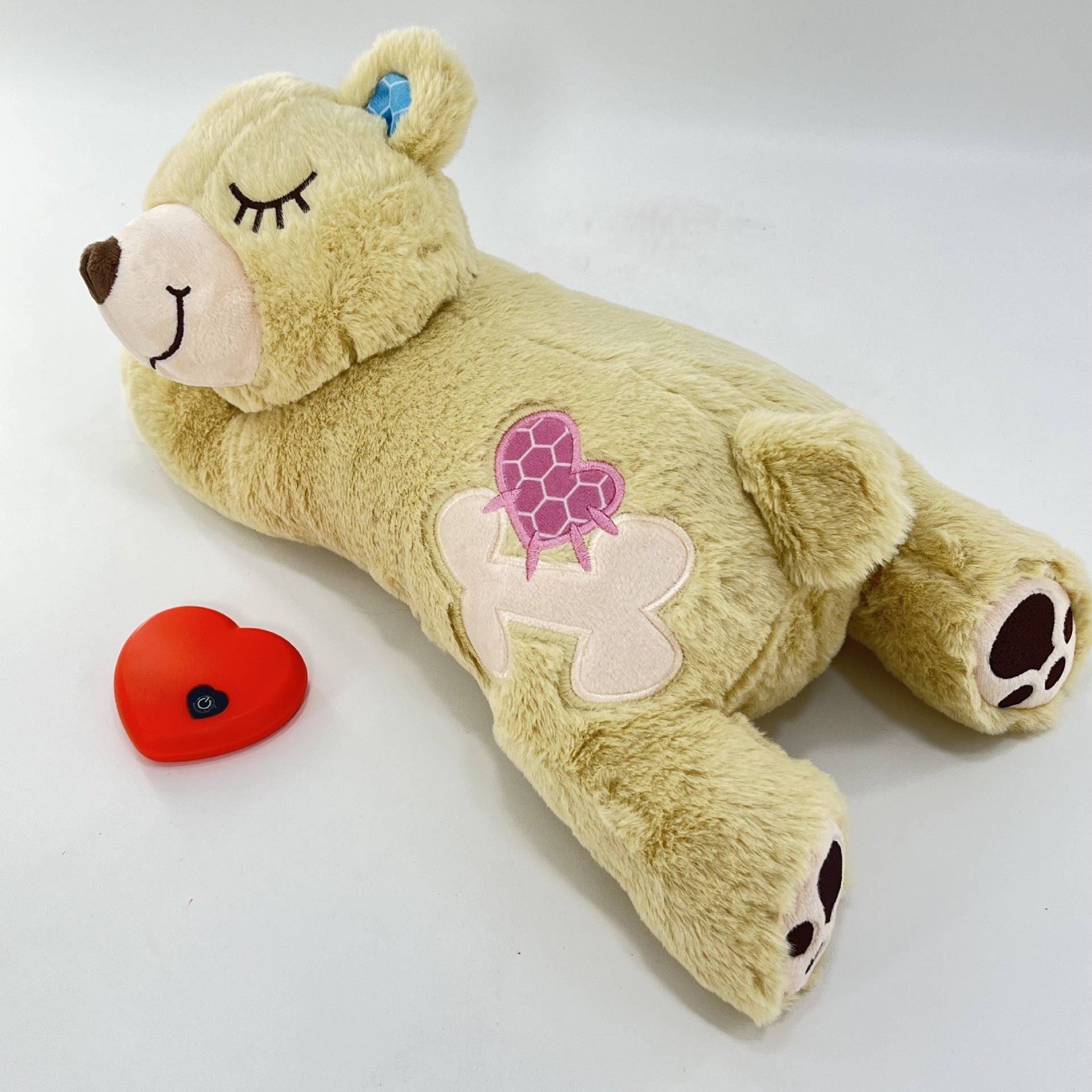 Plush toy bear with turtle design on a white background