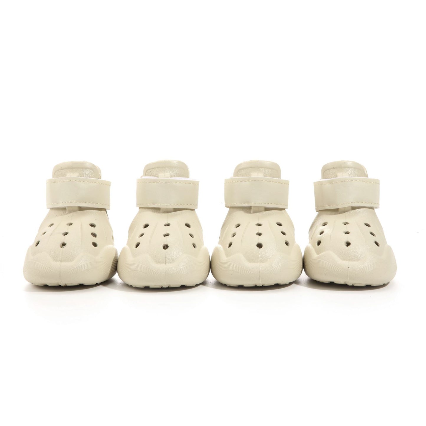 Set of 4 beige EVA Crocs-style dog sandals displayed on a neutral pastel background