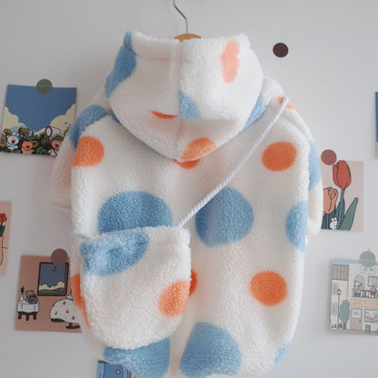 Pet fleece blue hoodie hanging on a wooden hanger, showcasing its design and texture.