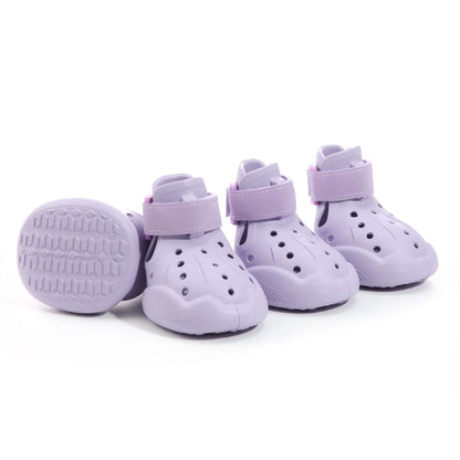 Set of 4 purple EVA Crocs-style dog sandals displayed on a neutral pastel background